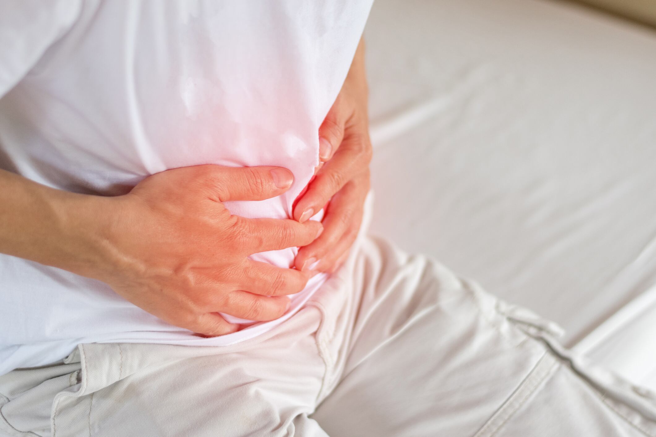 Man holding stomach in pain