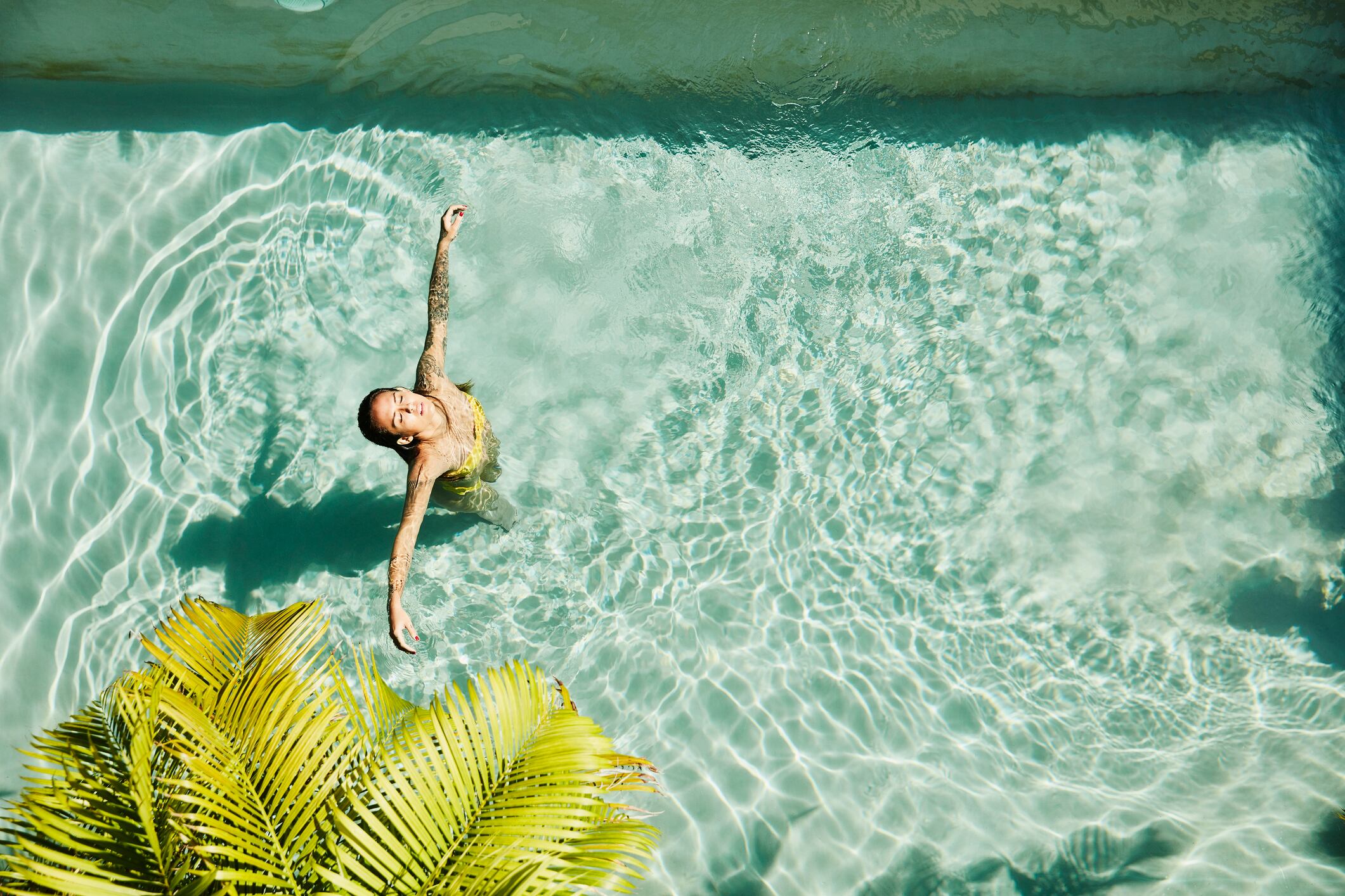 Longevity, health and beauty. Overhead view of woman relaxing in pool at outdoor spa