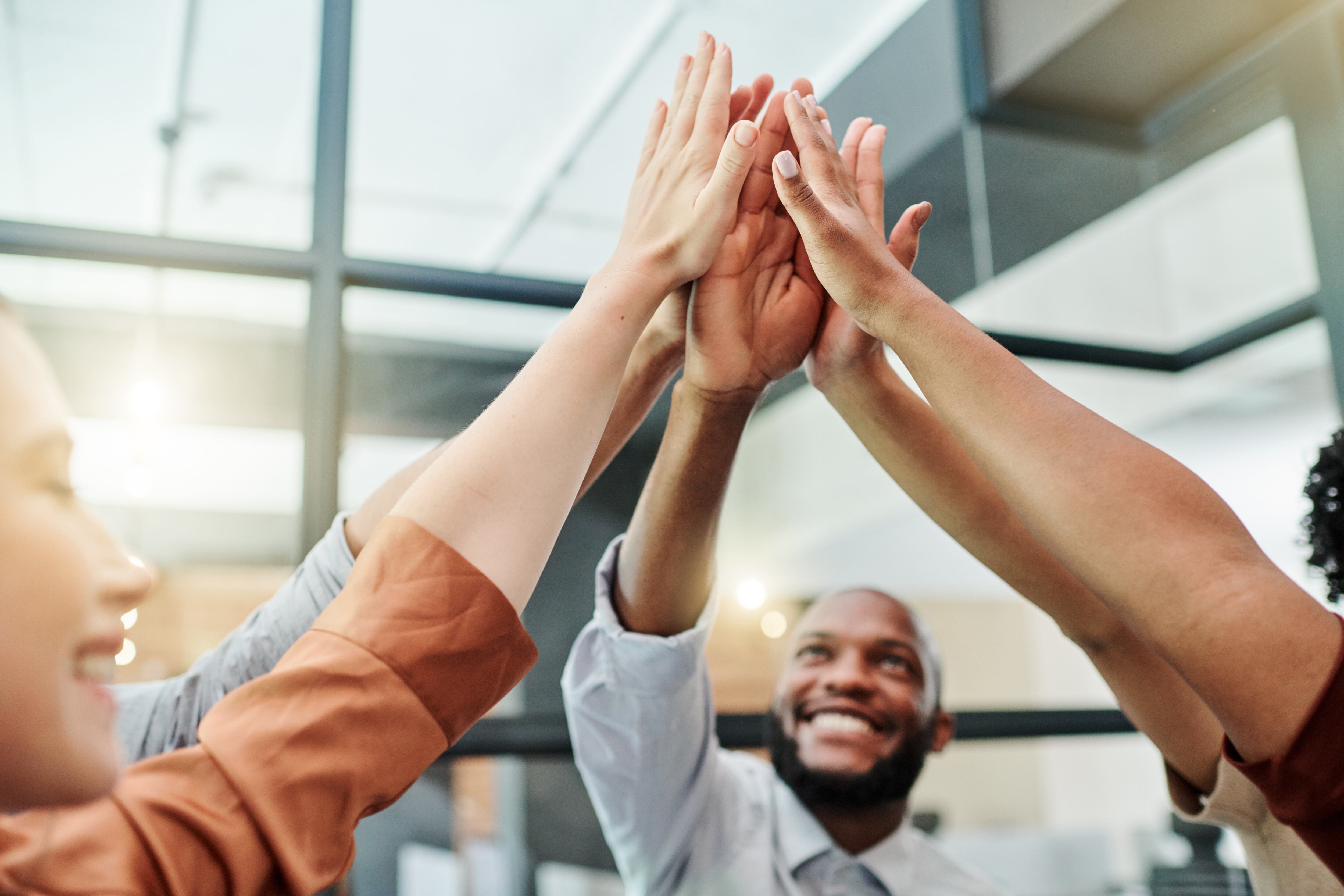 Group of happy business people giving a high five