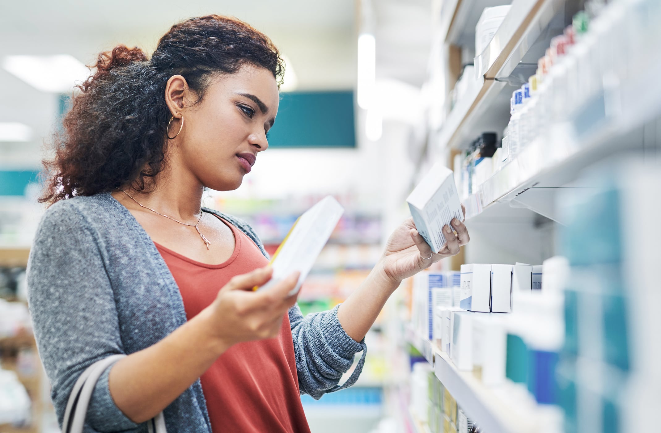 Shot of a young woman browsing the shelves for supplements