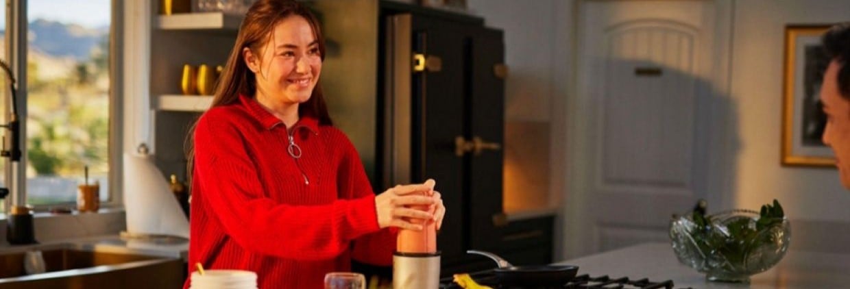 Woman making a drink in the kitchen