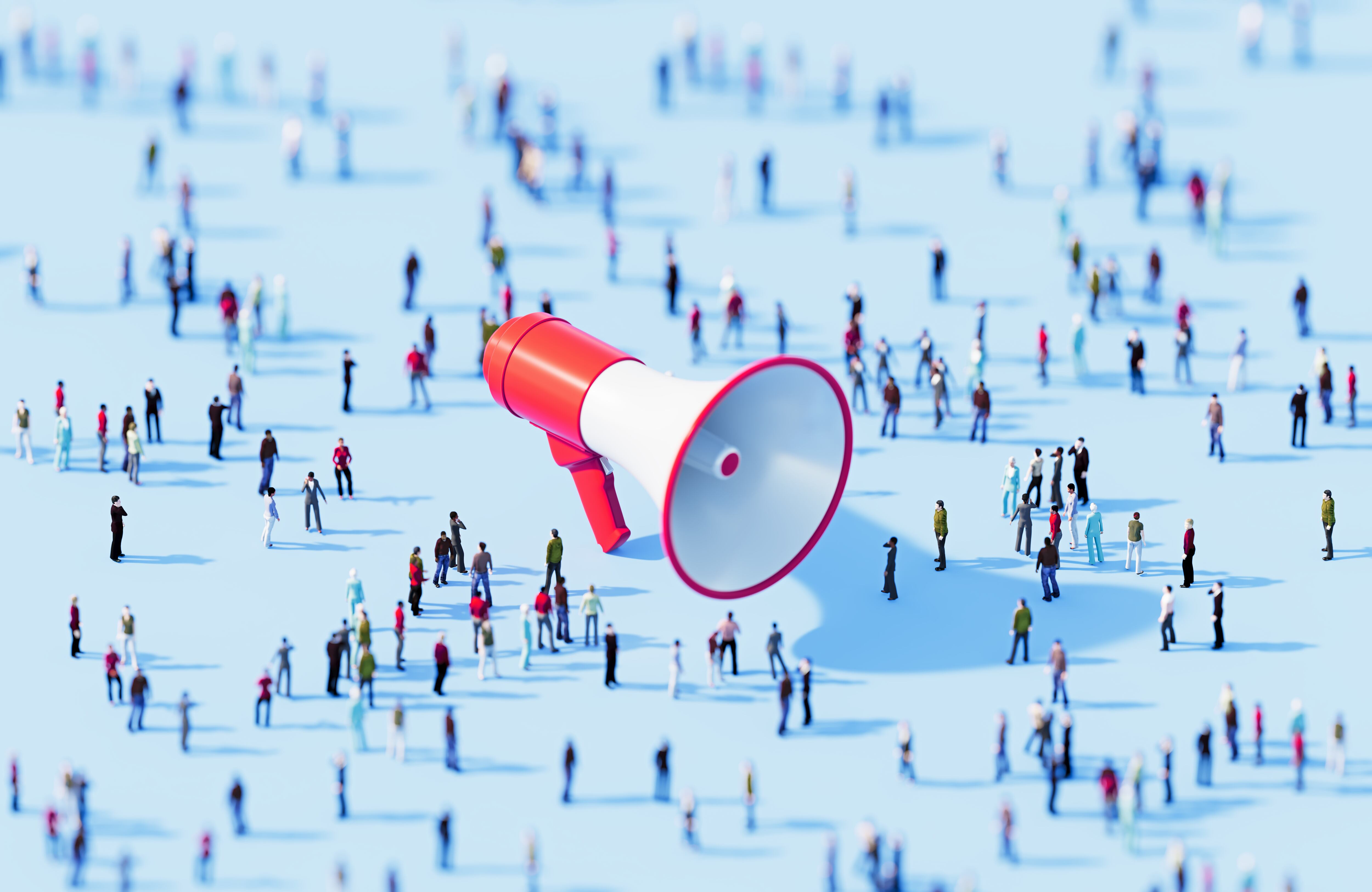 Human crowd surrounding red megaphone object on blue background. Horizontal composition with copy space.