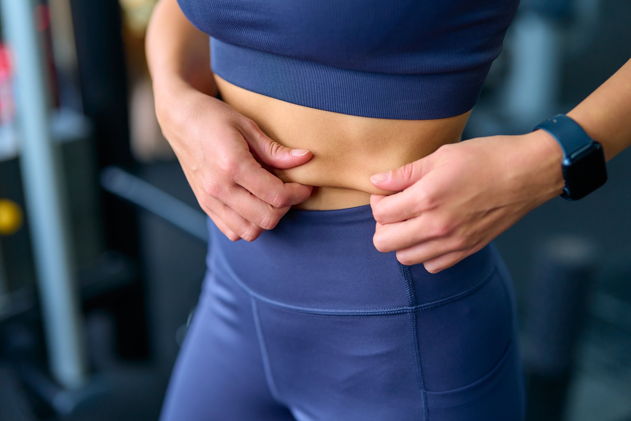 Woman pinching belly fat