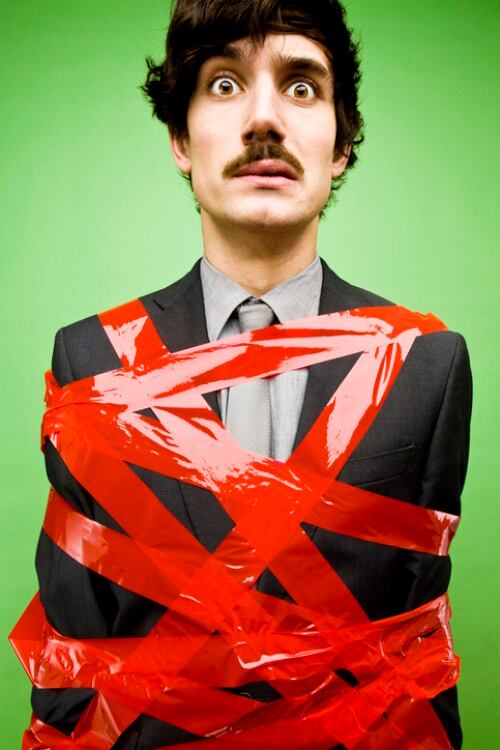 Businessman wrapped up in red tape