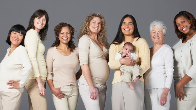 A group of smiling women at different life stages