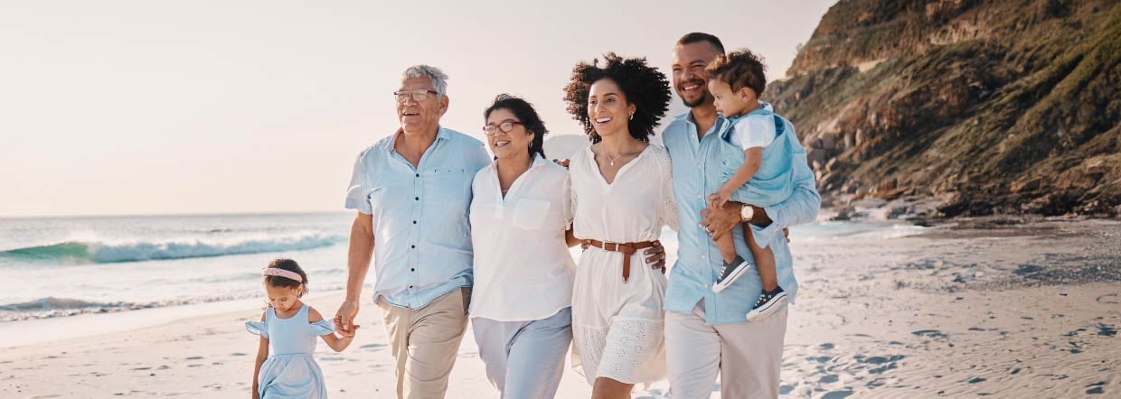 Happy family walking along the beach