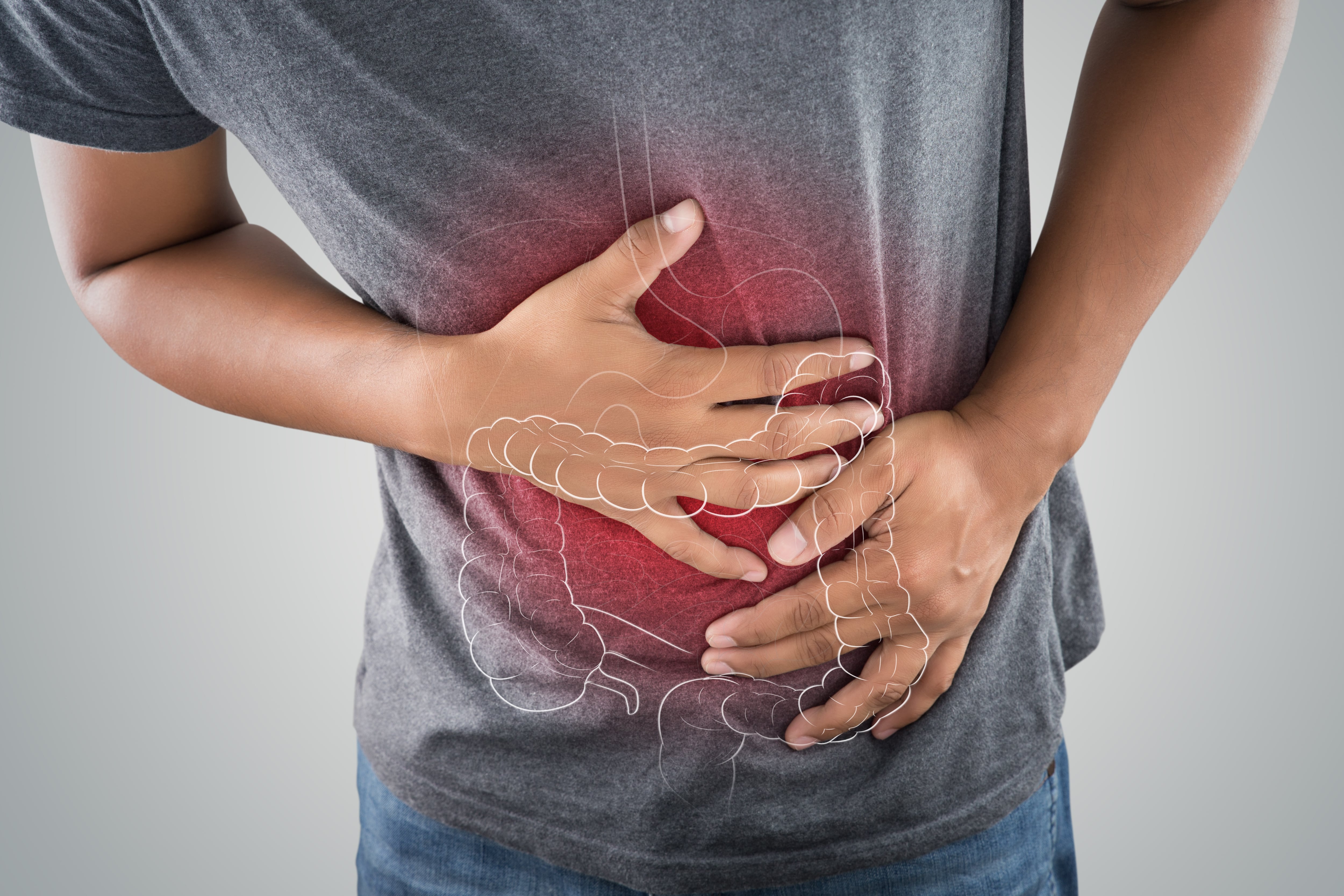 Man with stomach ache, overlaid with large intestine indicating gut issues