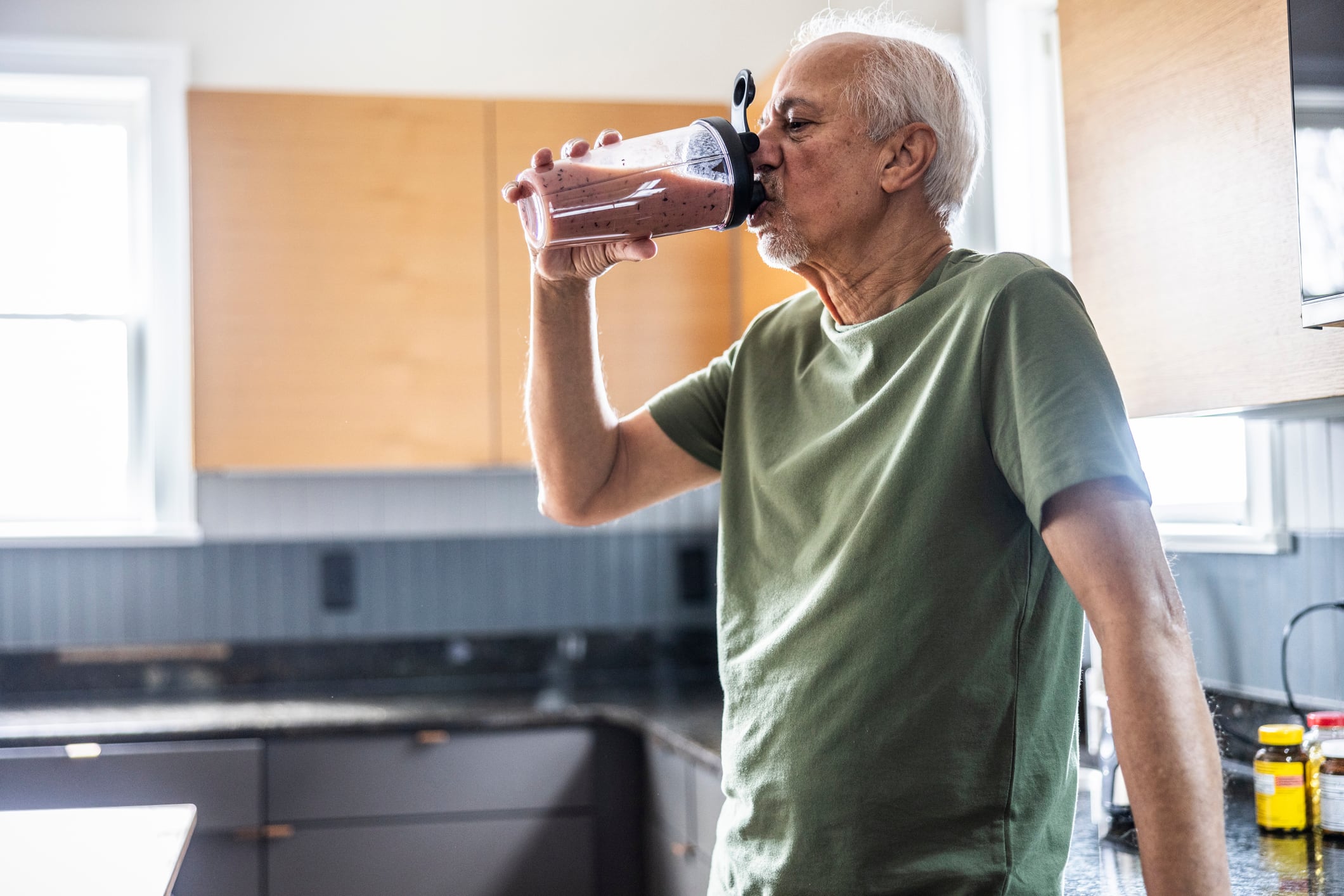 Senior man drinking a protein shake