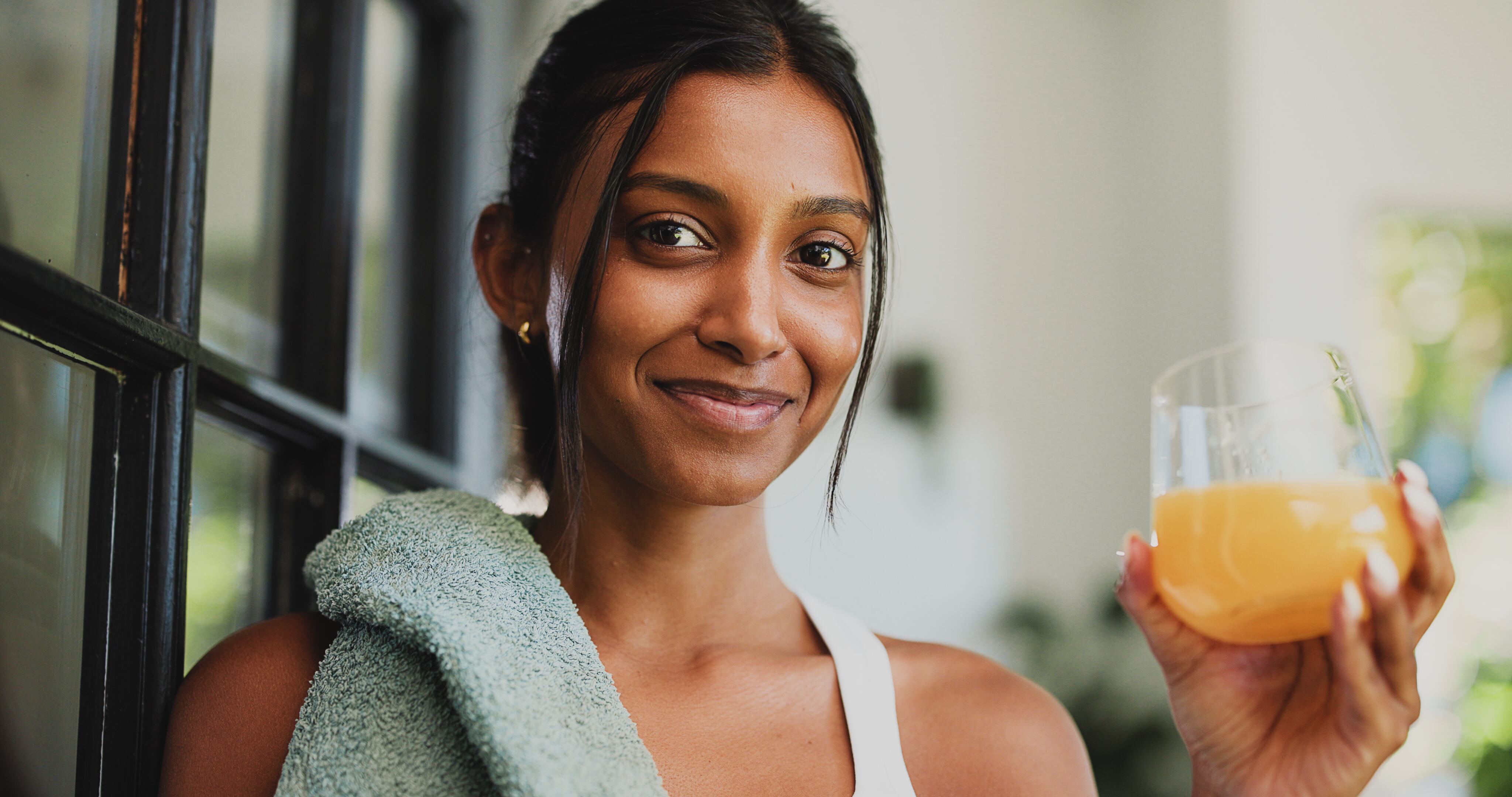 Indian woman with vitamin C drink