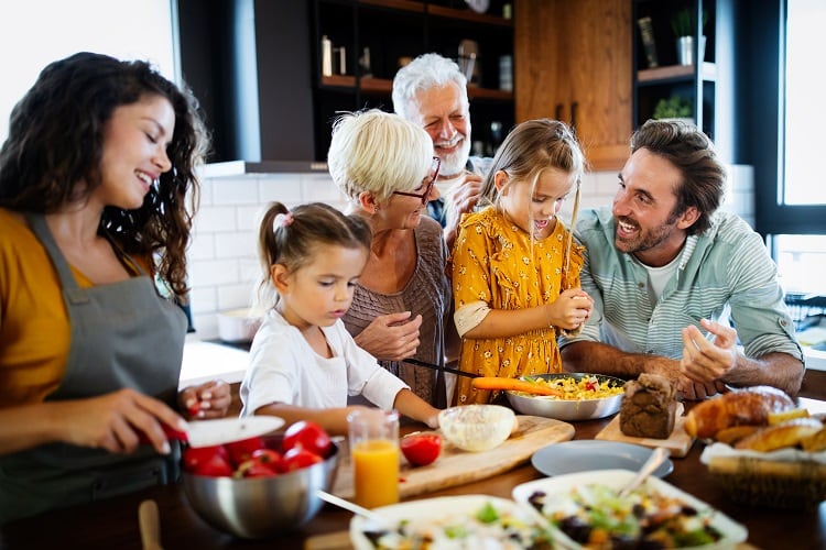 Grandparents, parents and children spending happy time in the kitchen. Family cooking concept