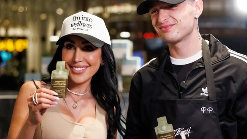 Cymbiotika cofounder Durana Elmi poses with Mexican singer and rapper Peso Pluma at the opening of the Cymbiotika Wellness Bar in Las Vegas.