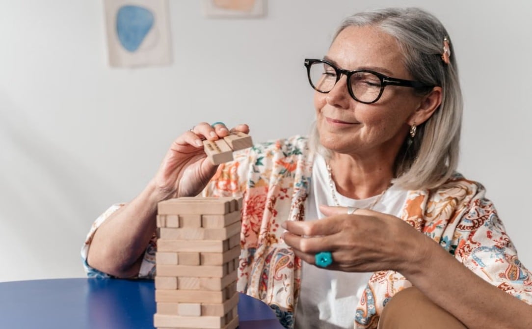 Older woman playing Jenga