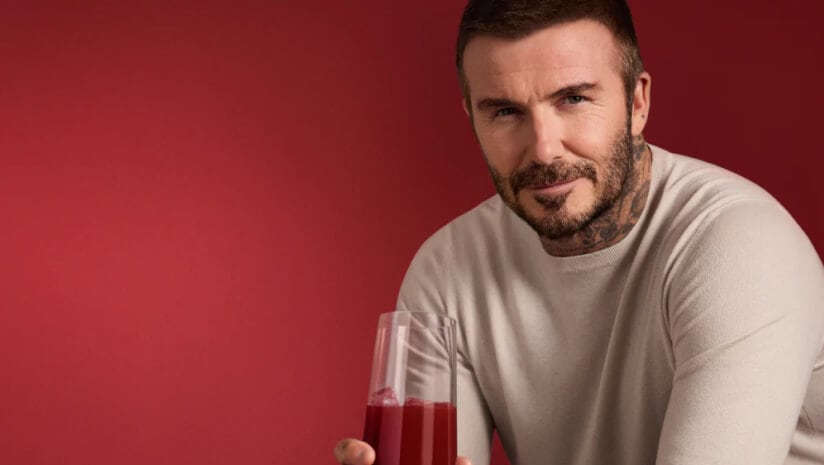 David Beckham drinking his IM8 brand's Daily Ultimate Essentials formula.