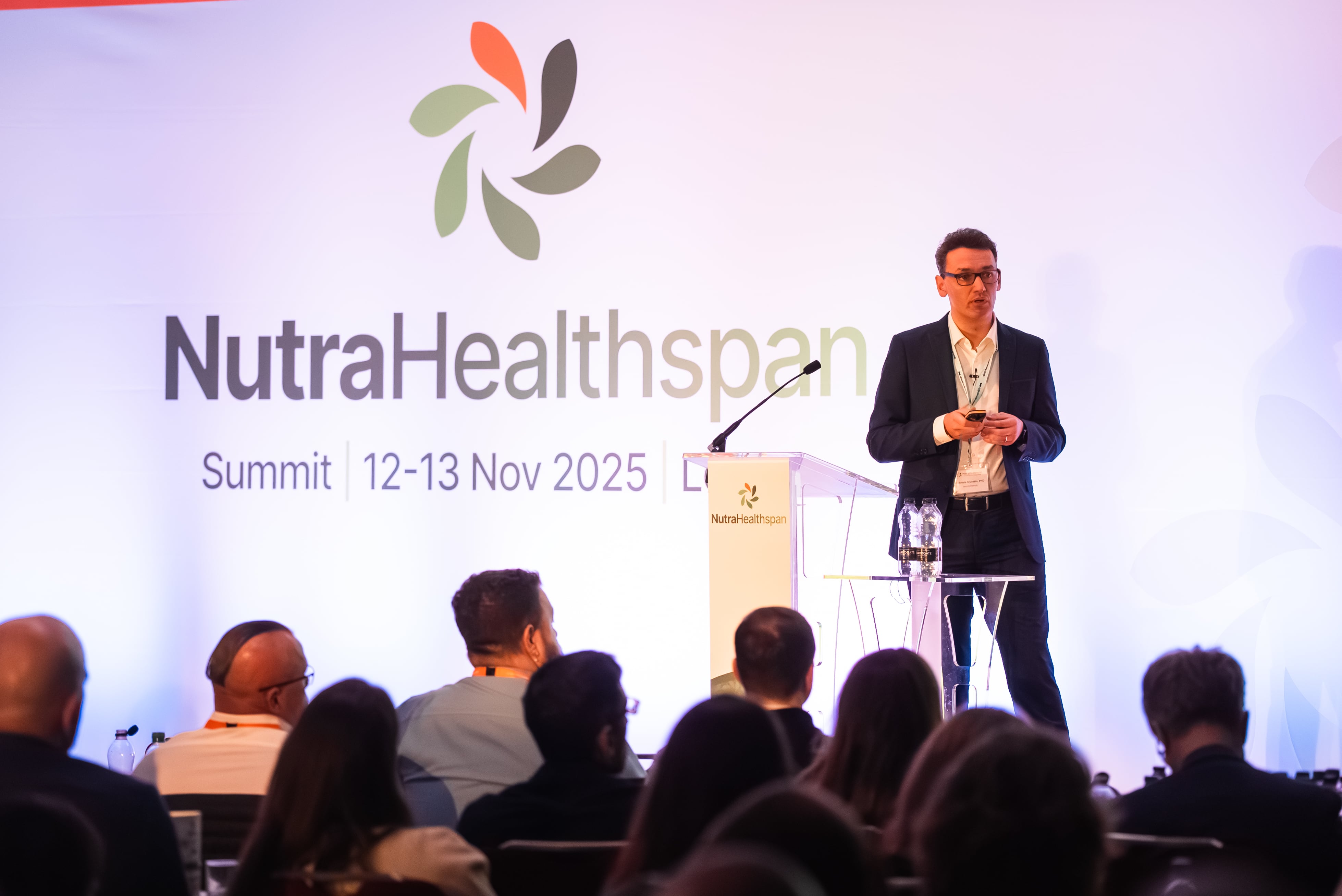 Dr. Gabriele Civiletto, dsm-firmenich, on stage at the Nutra Healthspan Summit in London.