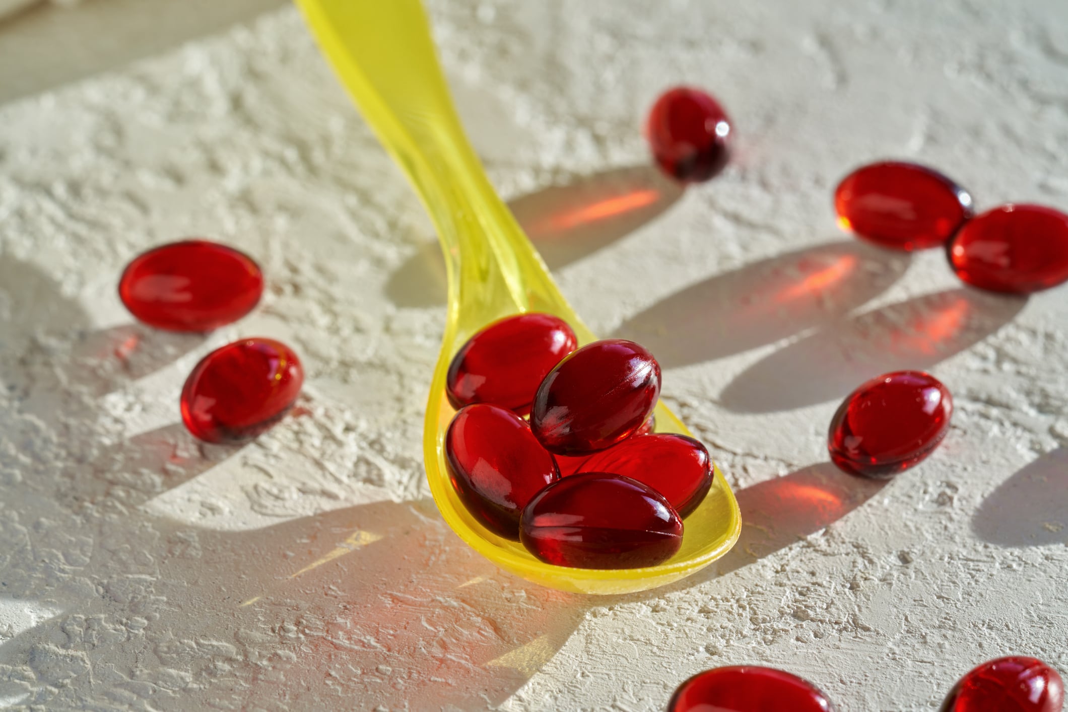 Krill oil capsules on a spoon - healthy nutritional supplement