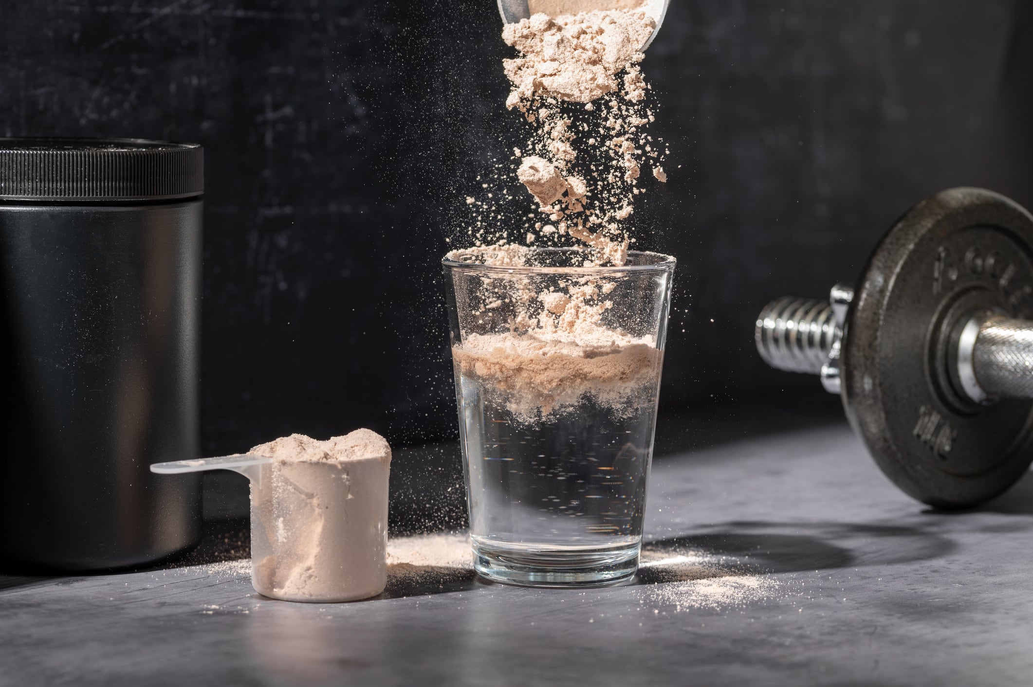 Pouring chocolate protein powder in a glass