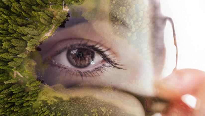 Multiple exposure of young woman holding eyeglasses with lake surrounded by trees.