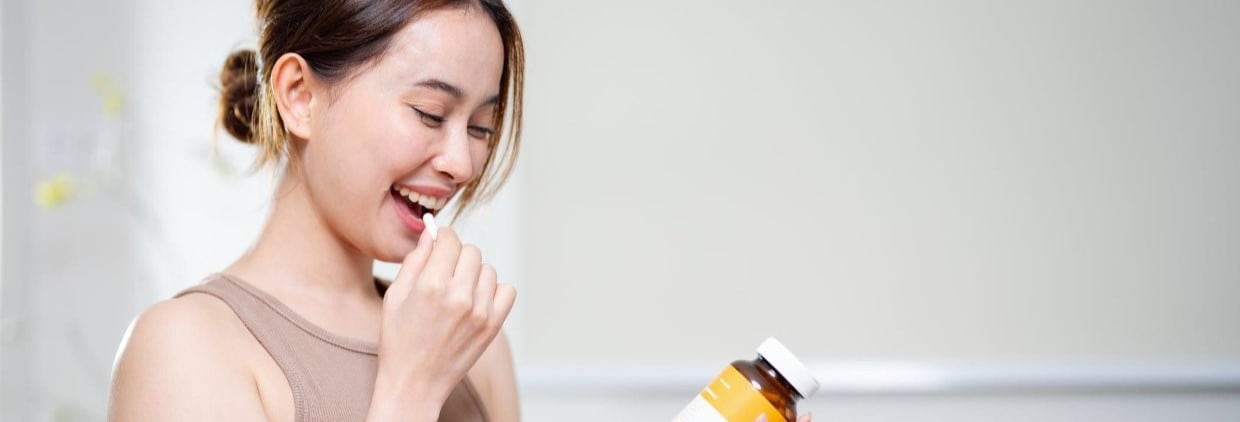 Woman taking supplement