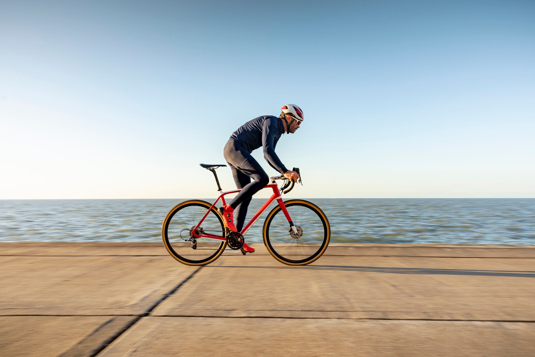 Cyclist on path by sea