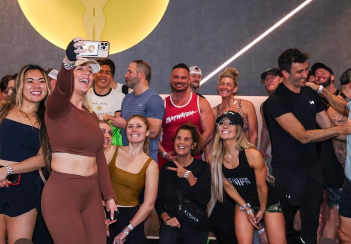 Diana Morgan poses for a selfie with other attendees at a recent gym session that took place alongside Expo West in Anaheim, CA.