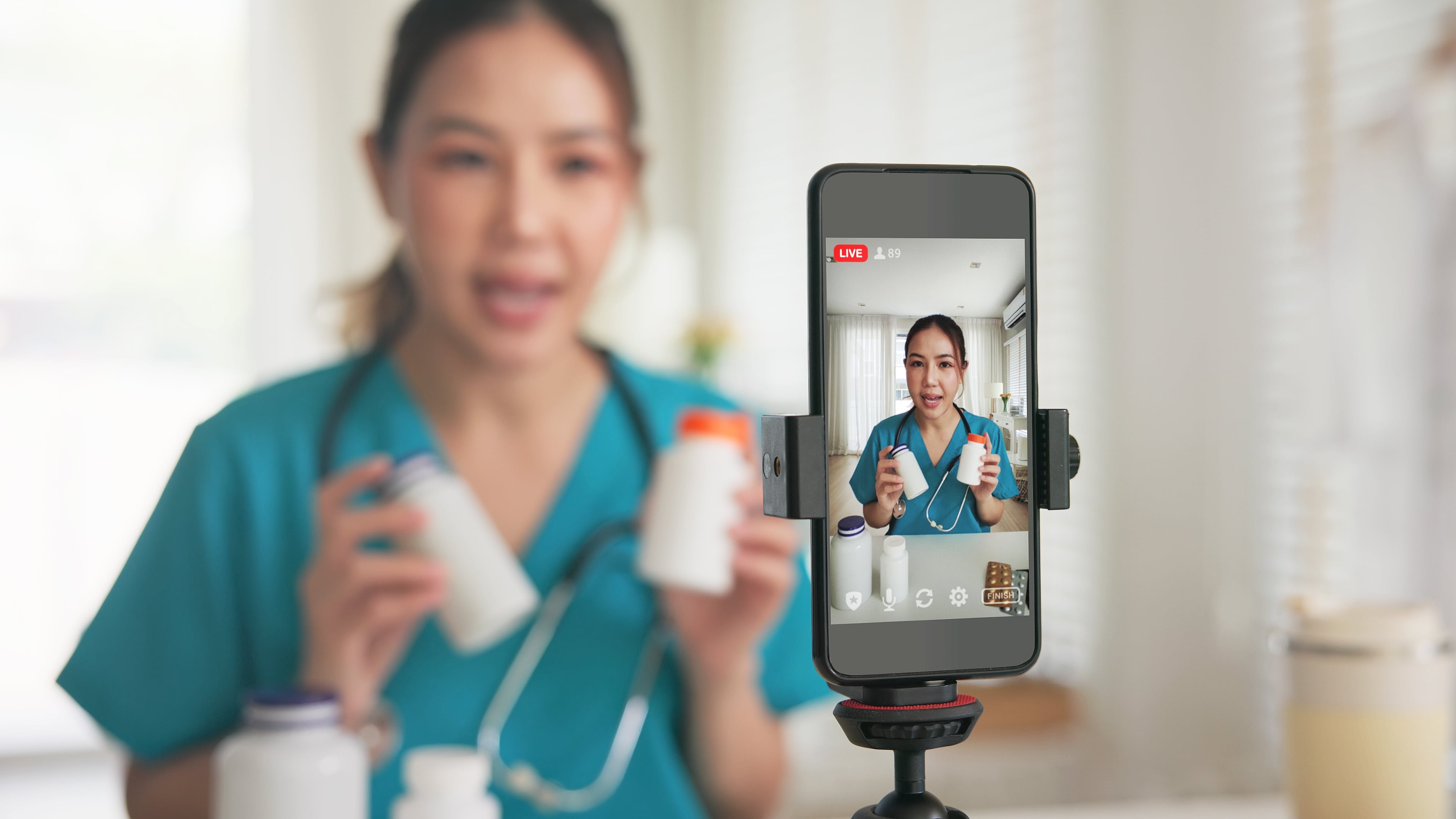 Healthcare professional holding supplement bottles in front of phone camera