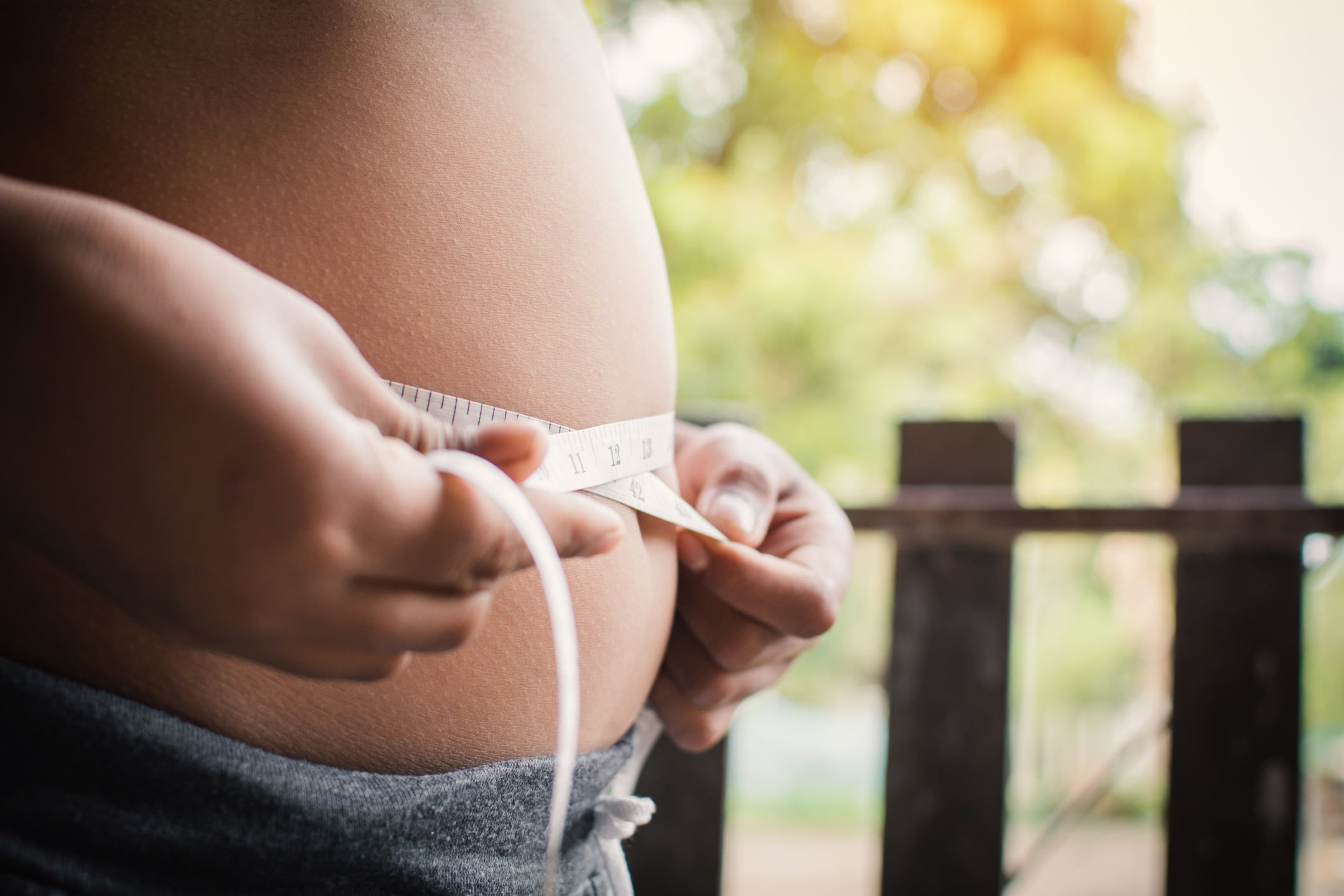 Portrait fat boy measuring tape of stomach,healthy and lose weight concept ,selective and soft focus