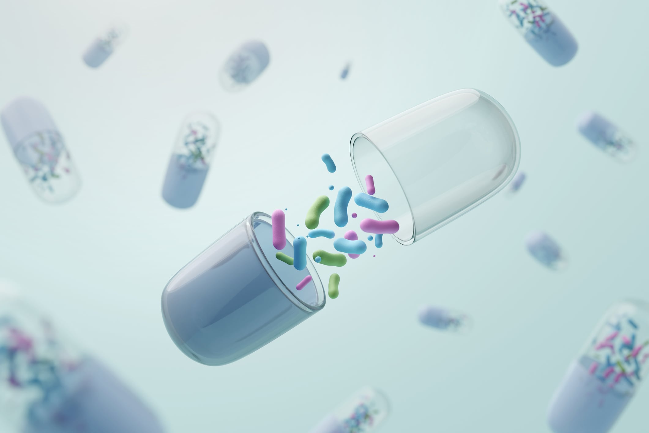 Opened medicine capsule revealing diverse multi-strain probiotic bacteria. 3D illustration for pharmaceutical innovation, advanced supplement, and nanotechnology concept.