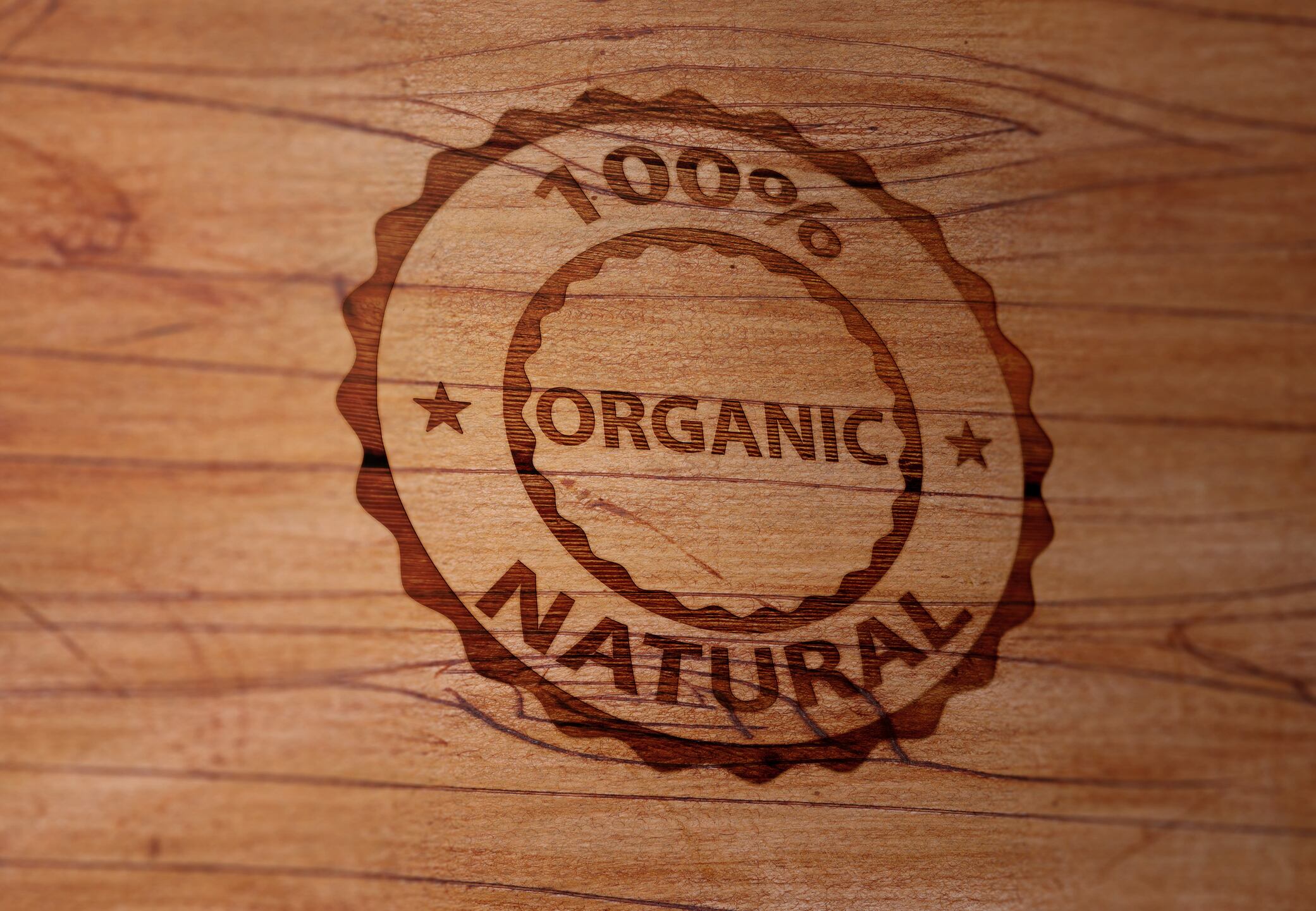 Wooden surface is stamped with "100 Percent Natural Organic" label. 3D rendering.