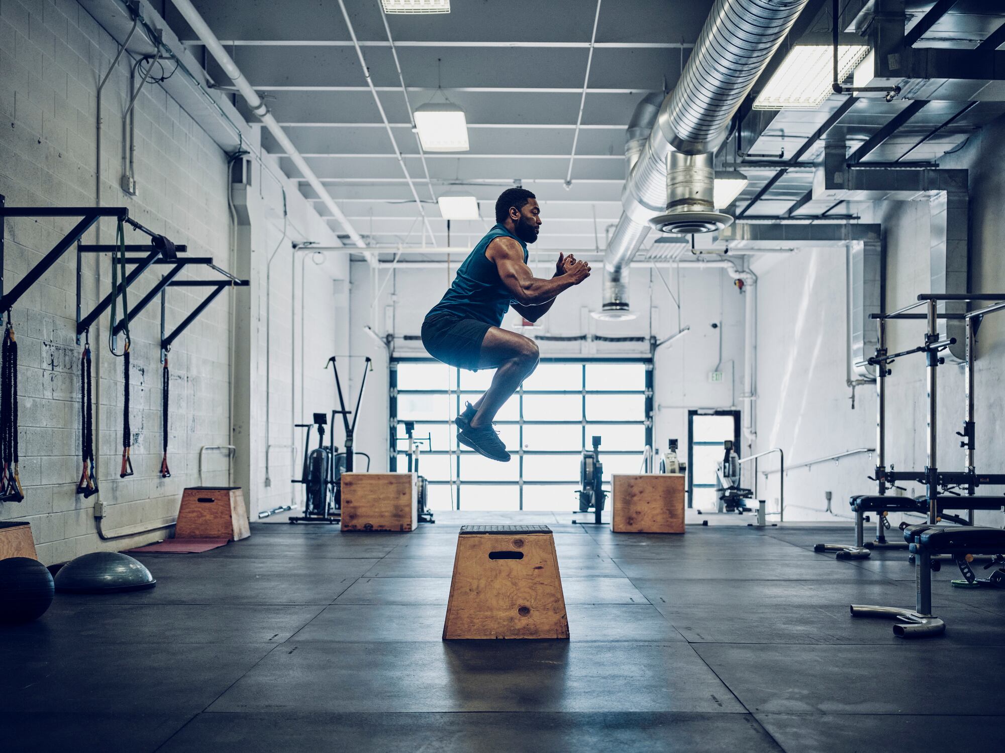 An athletic man cross training in a gym