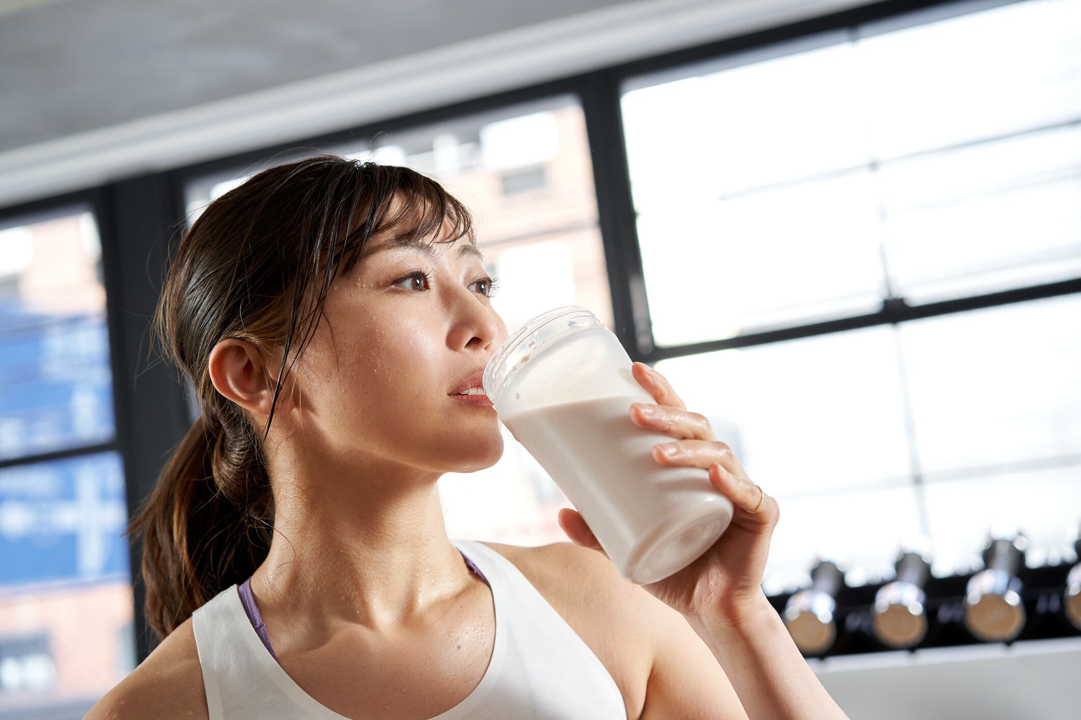 Asian woman drinking protein shake