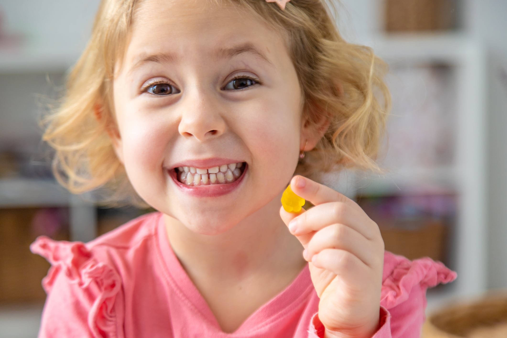 Child eating jelly candies at home. Selective focus. Food.