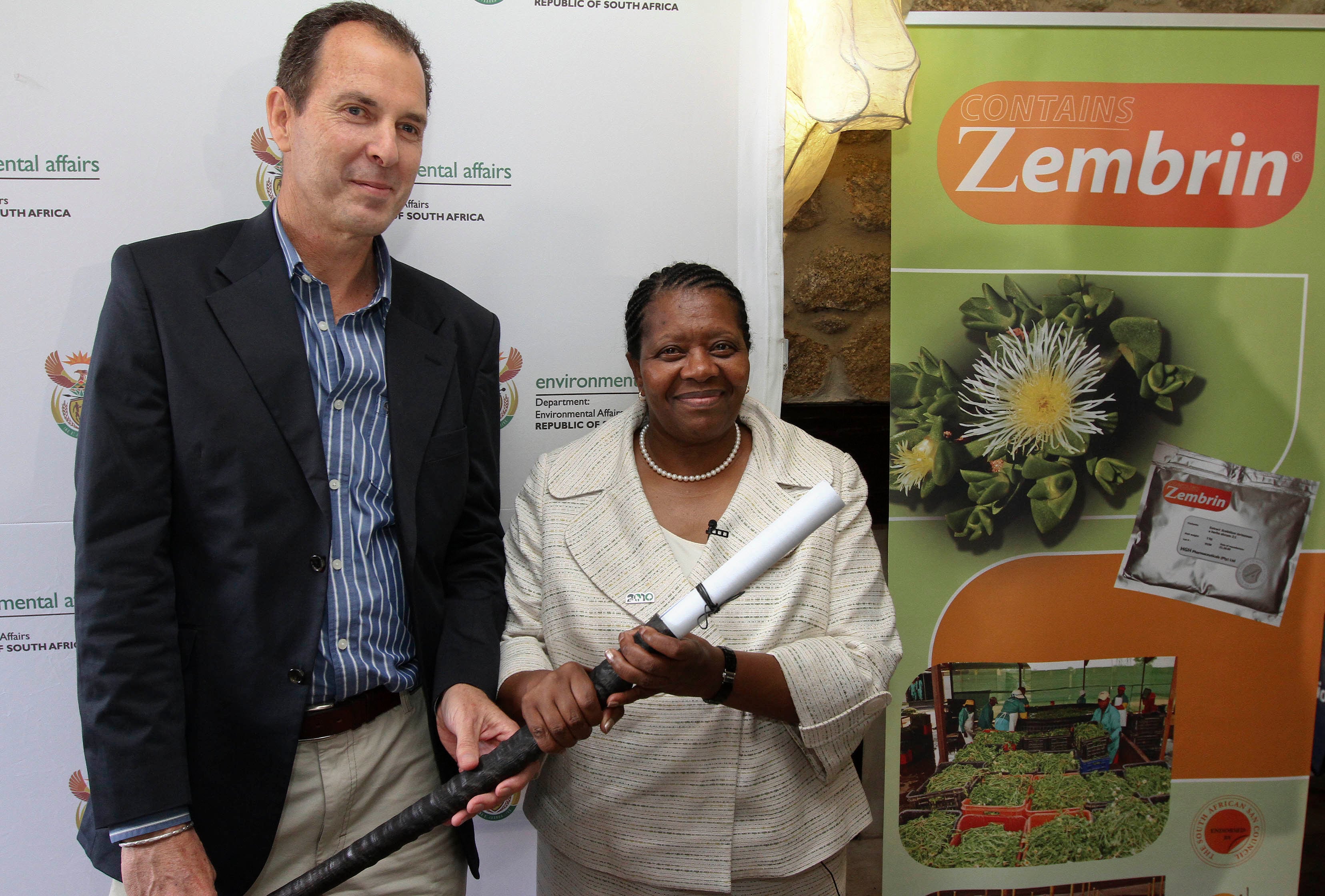 Minister of Water and Environmental Affairs, Ms. Buyelwa Sonjica ceremonially hands Dr. Nigel Gericke on behalf of HG&H Pharmaceuticals, South Africa's first ever Export and Bioprospecting Permit, in recognition of HG&H's sustainable cultivation of Sceletium and and prior informed consent benefit sharing agreement with the South African San Council. The permit is rolled into the top of a gemsbok horn.