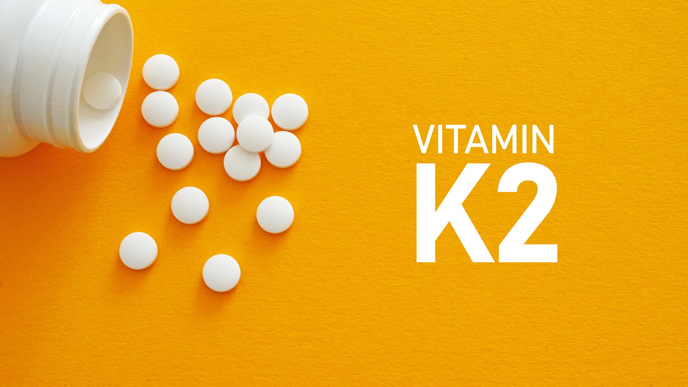 Vitamin K2 are shown using a text and photo of pills as medical concept