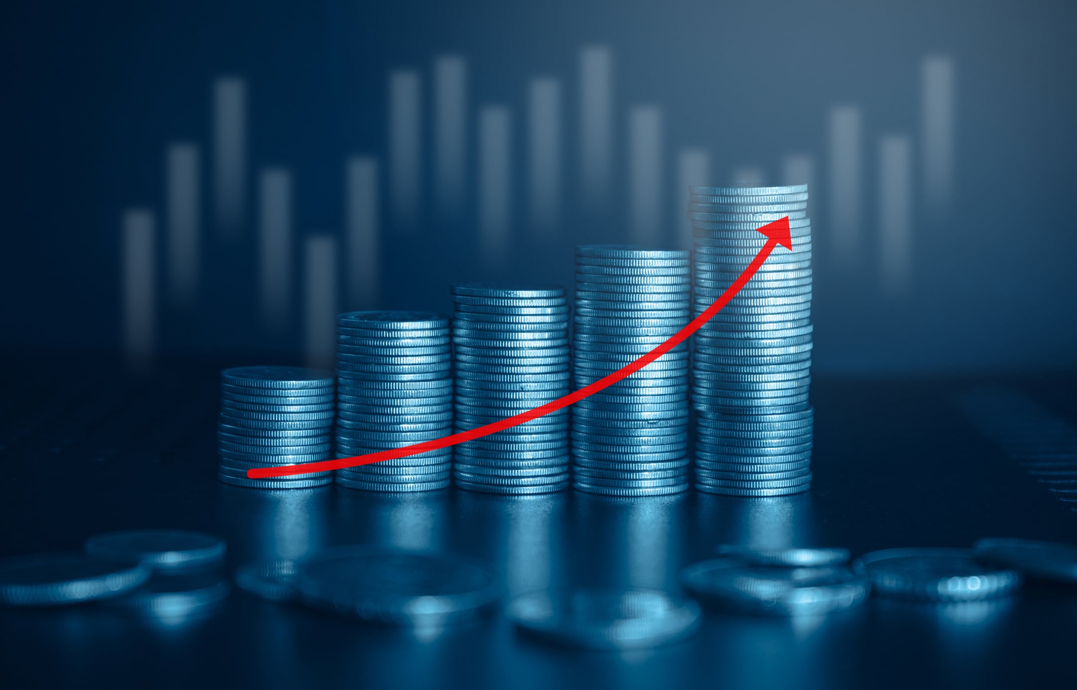 Stacks of coins with red arrow up. Financial growth concept. Business and financial background.