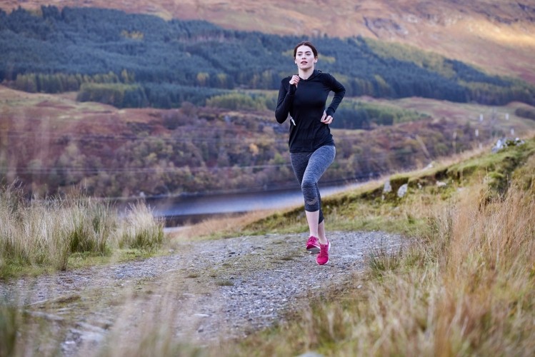 Woman running up a hill in the wilderness. Image © Plume Creative / Getty Images
